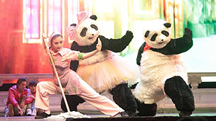 Two giant pandas and a kung fu performer