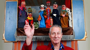 Konrad Fredericks with the Punch and Judy puppets and stage