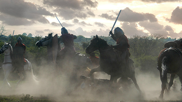 Knights on horseback fight each other in a battle