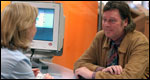A man being interviewed by a woman