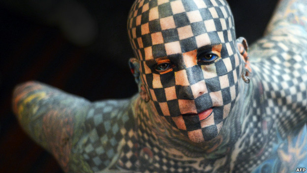 A heavily tattooed man
